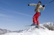 Snow Skier Jumping Against Blue Sky