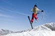 Snow Skier Jumping Against Blue Sky