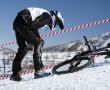 Snow biker downhill in winter mountains