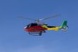 Red Helicopter with team over blue sky