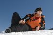 Teenager boy with player in winter mountains