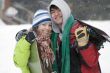 A lifestyle image of two teens snowboarders