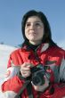 Attractive woman in sport wear holding a camera