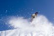 Snow Skier Jumping Against Blue Sky