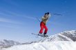 Snow Skier Jumping Against Blue Sky