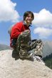 Teenager in red sport pullover in mountain