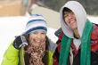 A lifestyle image of two young snowboarders