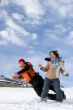 Couple jump over blue sky in winter