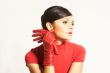 Atractive brunet in red blouse and red gloves