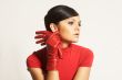 Atractive brunet in red blouse and red gloves