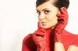 Atractive brunet in red blouse and red gloves