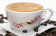 Cup of coffee and grains over white
