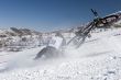 Snow biker downhill in winter mountains