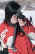 Attractive woman in sport wear holding a camera