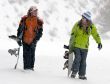 A lifestyle image of two young snowboarders