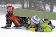 A lifestyle image of two young  snowboarders