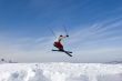 Snow Skier Jumping Against Blue Sky