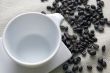 Cup of coffee and grains over sackcloth