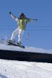 Snowboarder pull-up a sweet grab off a jump