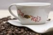 Cup of coffee and grains over sackcloth
