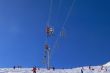 Chairlifts & skiers, against blue sky