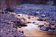 Mountain stream and lilac stones in Tien Shan