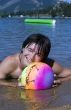 Teenager with variegated ball on the beach