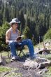 Teenager with  book close to camp-fire