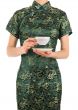 Woman in Chinese dress holding a cup of tea