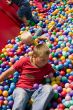 Boys playing in colourful ball pool