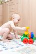 Baby play with toys in the room