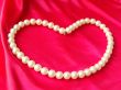 Heart from pearls on a red background