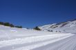 Tracks on snow covered road in mountain