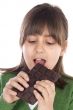 adorable girl eating chocolate
