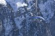 Hovering paraglider in the mountains