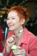 woman eating ice cream in cafe and smiling happy
