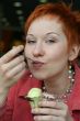 woman eating ice cream in cafe and smiling happy