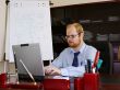 Man in his office is working at laptop