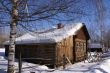 Old wooden house in snow