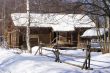 Old wooden house in snow