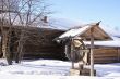 Old wooden house and draw-well