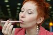 woman is licking a tubule in cafe and smiling happy