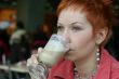 woman dreanking coffe in cafe and thoughtfully looks afar