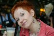 woman dreanking coffe in cafe and thoughtfully looks afar