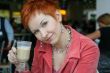 woman dreanking coffe in cafe and thoughtfully looks afar