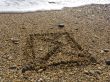 envelope on wet sea sand