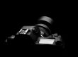 SLR camera on black spot light