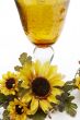Big yellow wineglass with bouquet of sunflowers