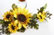Big yellow wineglass with bouquet of sunflowers