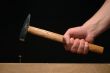 Man’s hand holding hammer